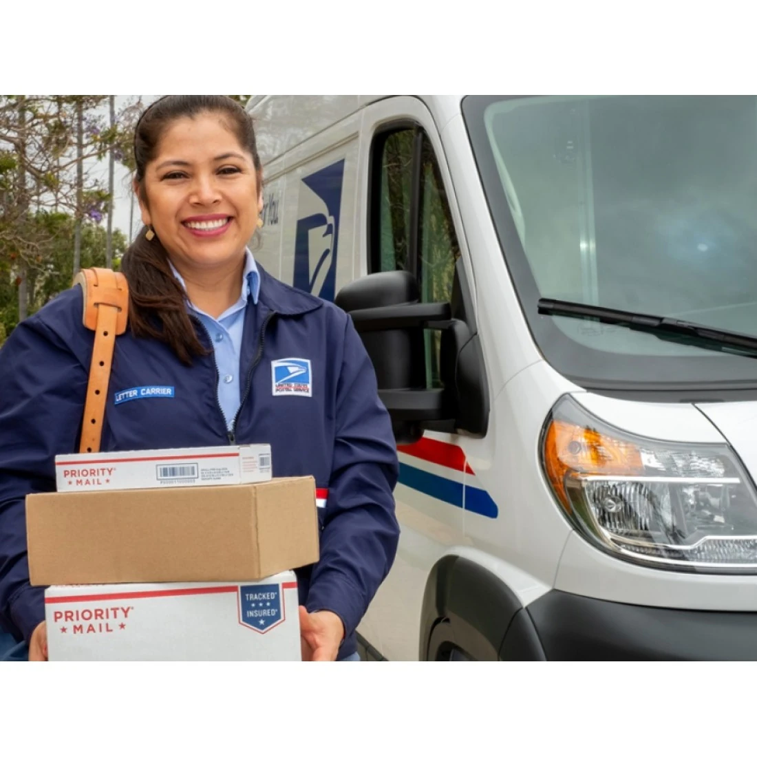 Collector holding a magnifying glass examining appalachian trail stamps 2025 pane for grading